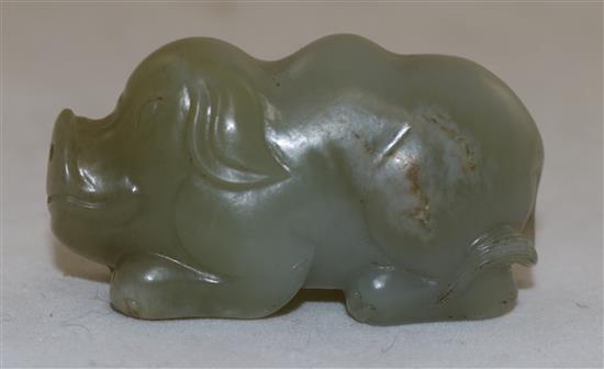 A Chinese pale celadon jade figure of a recumbent pig, 19th century, 5.6cm